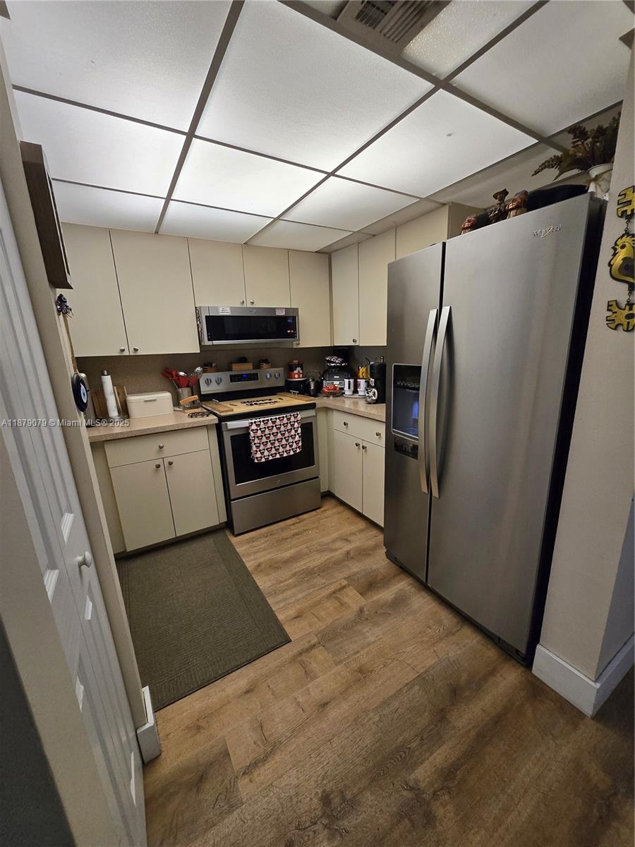 12095 Southwest 18th Terrace, Unit 267 Miami, FL 33175 - Photo 15 of 45 a kitchen with stainless steel appliances granite countertop a refrigerator and a stove top oven