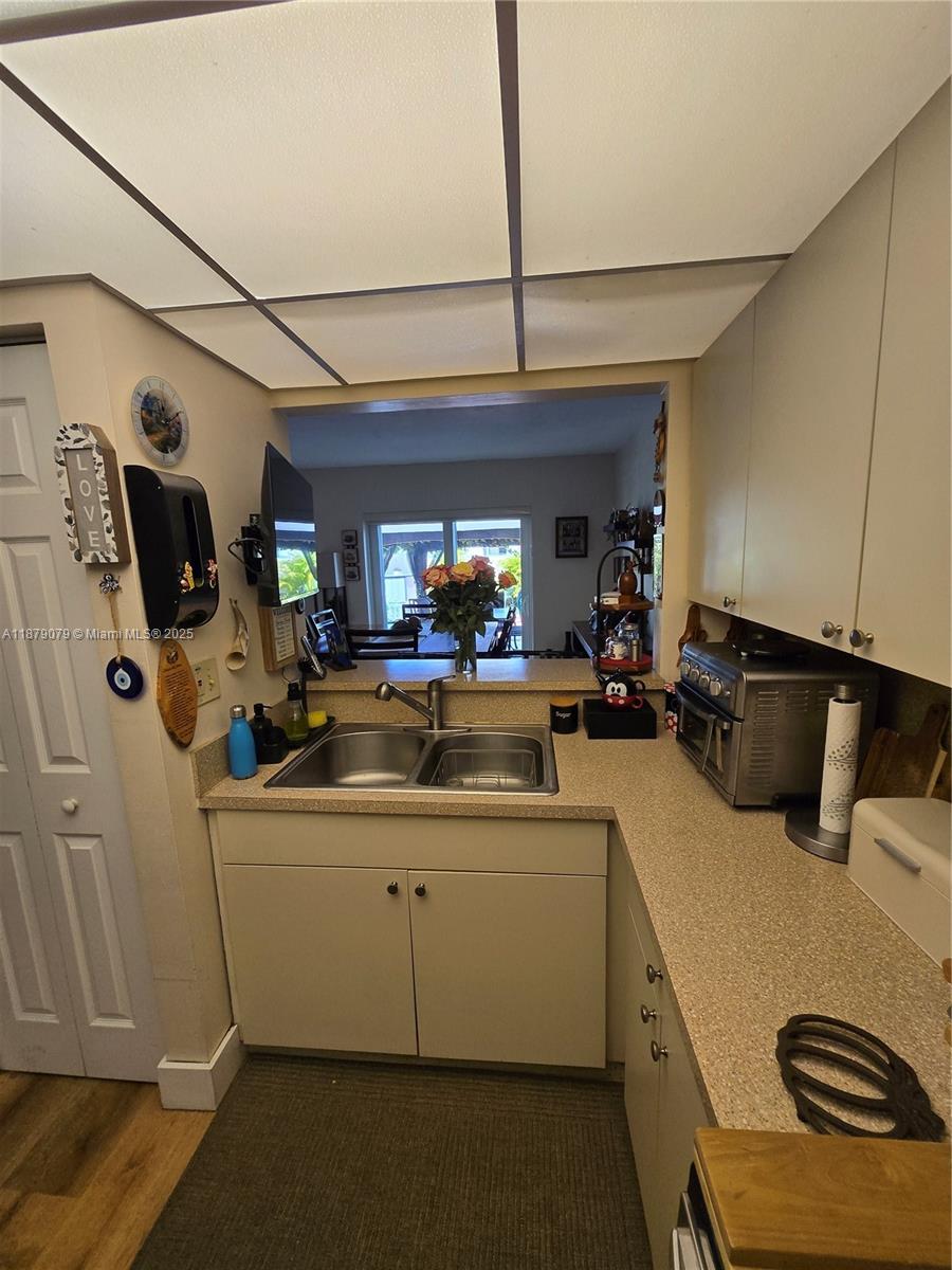 12095 Southwest 18th Terrace, Unit 267 Miami, FL 33175 - Photo 16 of 45 a kitchen with a sink appliances and cabinets