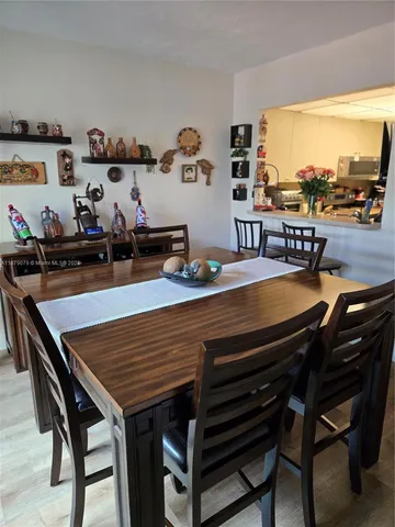 a view of a dining room with furniture and a floor to ceiling window