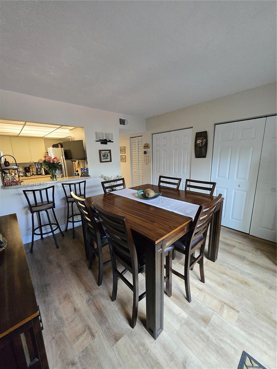 12095 Southwest 18th Terrace, Unit 267 Miami, FL 33175 - Photo 21 of 45 a dinning table and chairs in a room