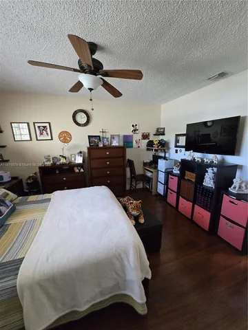 a bedroom with a bed and dresser