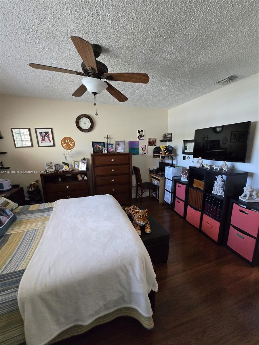12095 Southwest 18th Terrace, Unit 267 Miami, FL 33175 - Photo 24 of 45 a bedroom with a bed and dresser