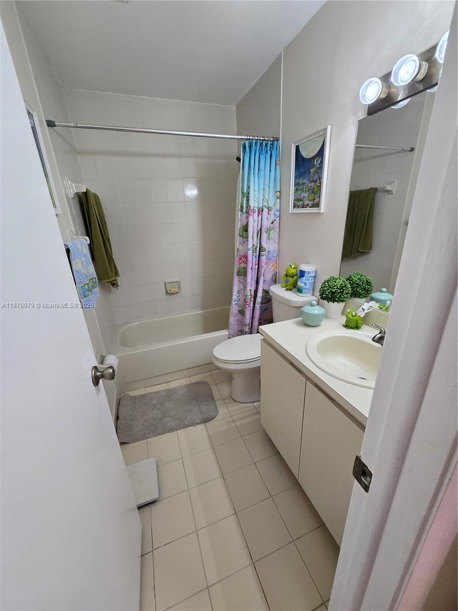 12095 Southwest 18th Terrace, Unit 267 Miami, FL 33175 - Photo 26 of 45 a bathroom with a sink a toilet and shower