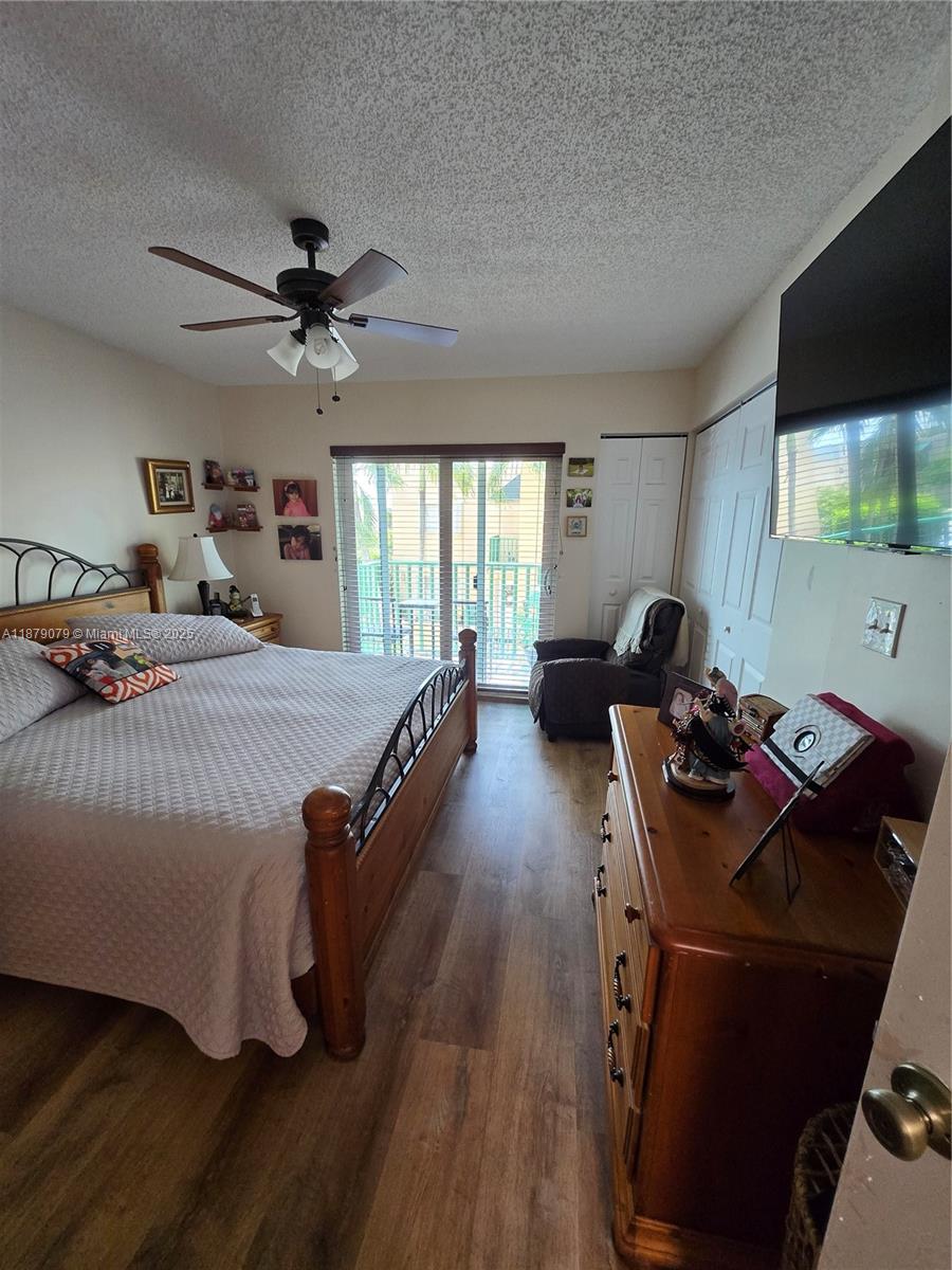 12095 Southwest 18th Terrace, Unit 267 Miami, FL 33175 - Photo 30 of 45 a bedroom with a bed and a flat screen tv