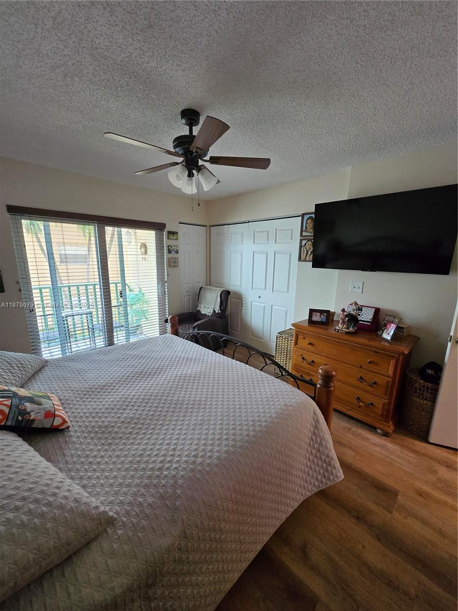 12095 Southwest 18th Terrace, Unit 267 Miami, FL 33175 - Photo 31 of 45 a bedroom with a bed and a flat screen tv