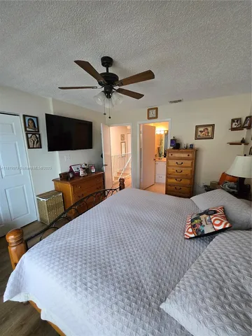 a bedroom with furniture and a flat screen tv