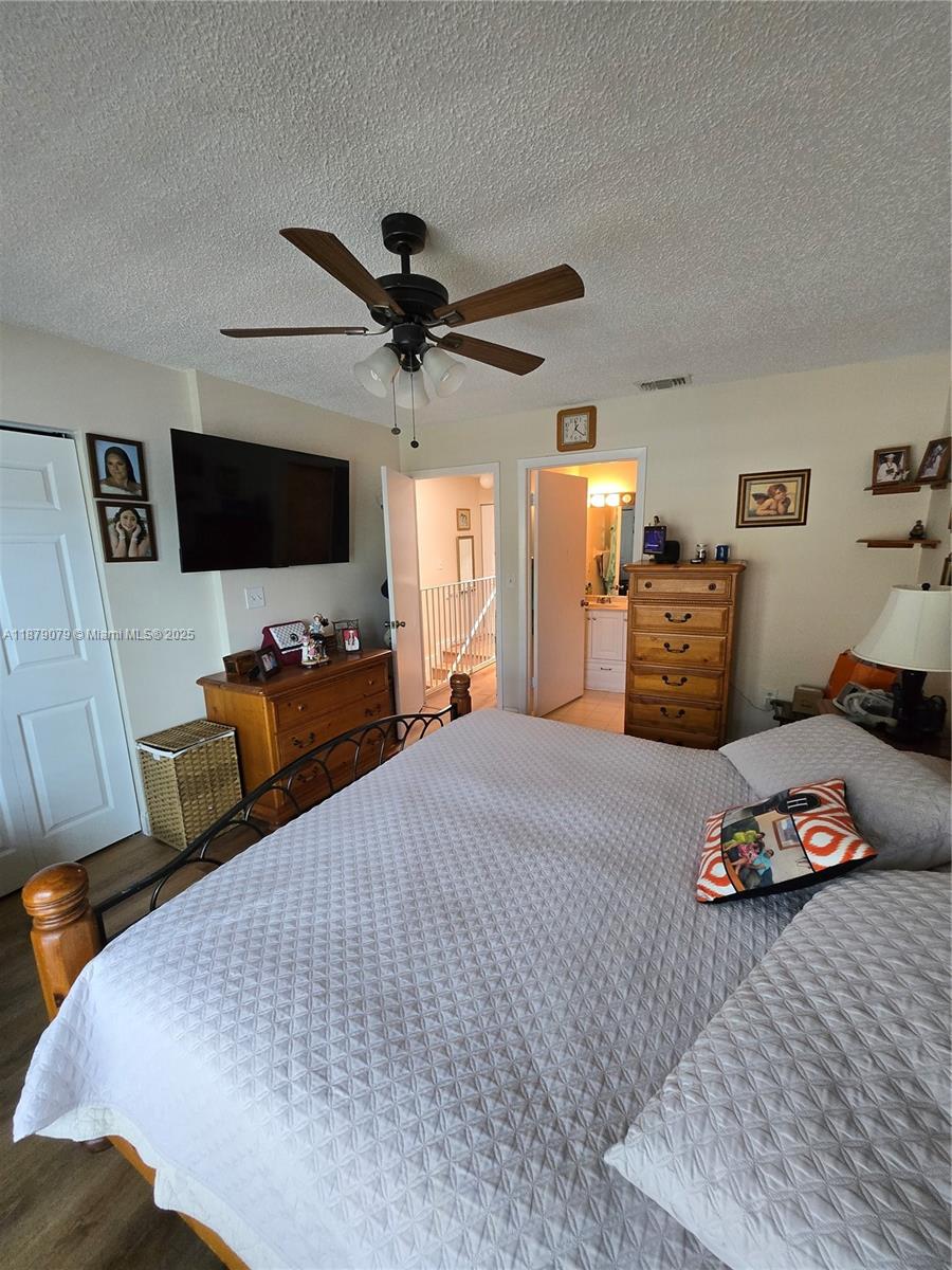 12095 Southwest 18th Terrace, Unit 267 Miami, FL 33175 - Photo 32 of 45 a bedroom with furniture and a flat screen tv