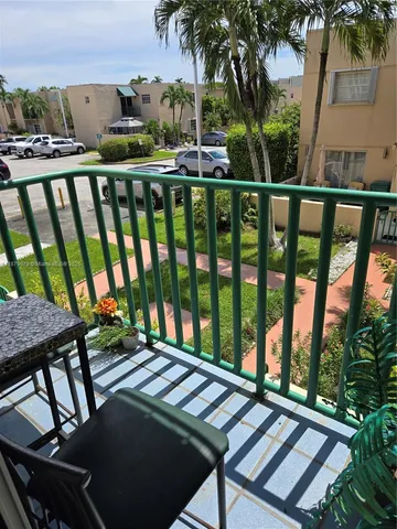 a view of a balcony with furniture