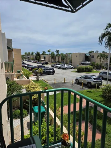a view of a hallway with wooden floor and stairs