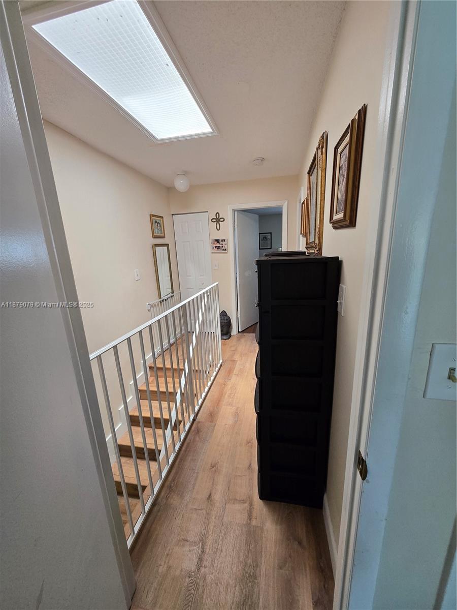 12095 Southwest 18th Terrace, Unit 267 Miami, FL 33175 - Photo 42 of 45 a view of a hallway with wooden floor and stairs