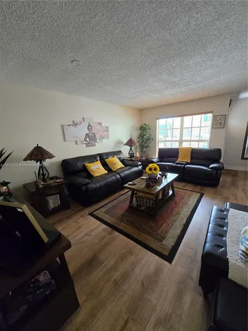a living room with furniture rug and window