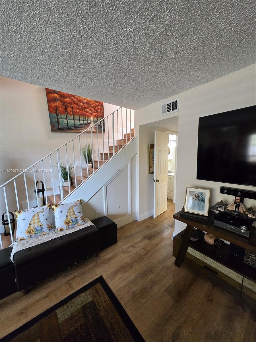 12095 Southwest 18th Terrace, Unit 267 Miami, FL 33175 - Photo 6 of 45 a living room with furniture and a flat screen tv
