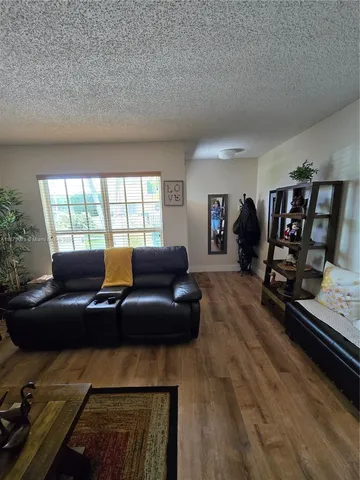 a living room with furniture window and wooden floor