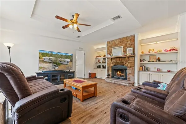 a living room with furniture a fireplace and a flat screen tv