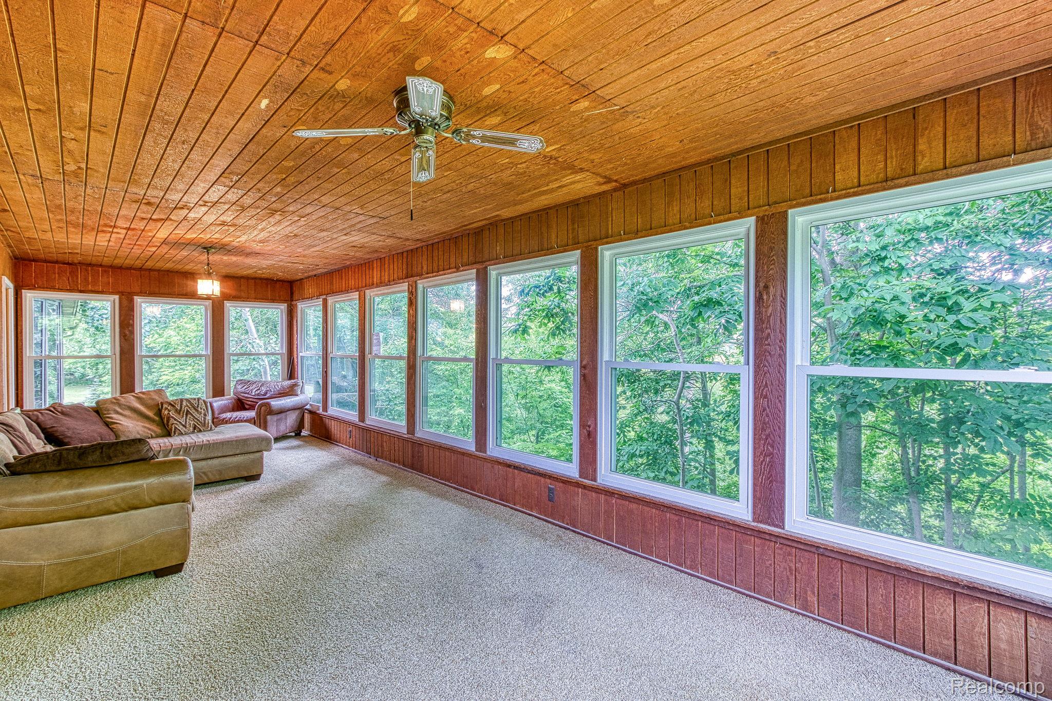 12012 Belle River Road Memphis, MI 48041 - Photo 20 of 41 Sunroom / solarium with wood walls, wood ceiling, and carpet