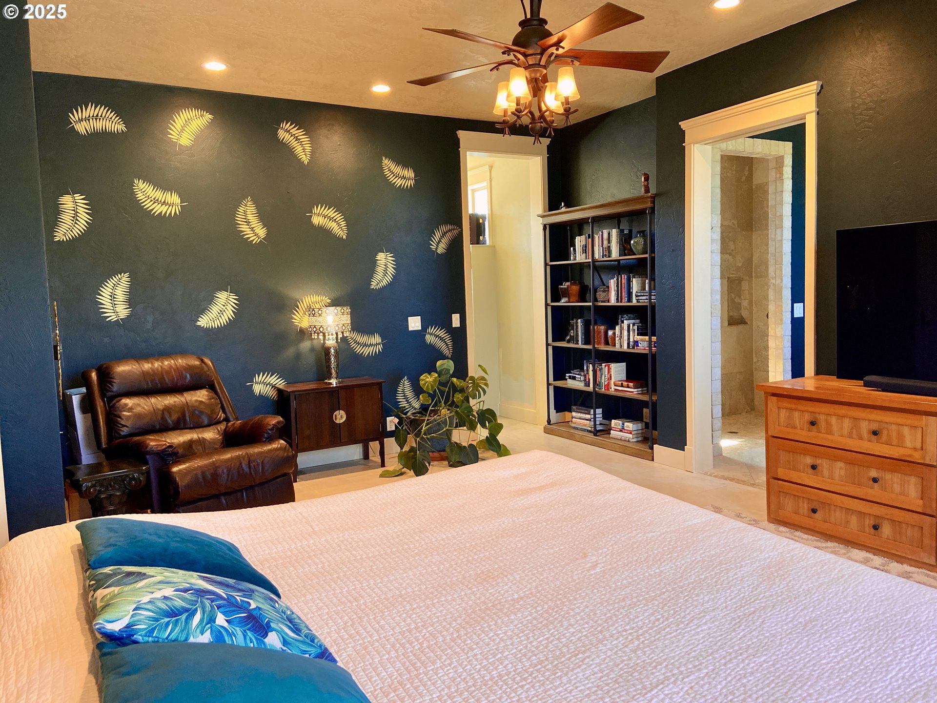 625 St Andrews Loop Creswell, OR 97426 - Photo 27 of 31 a spacious bedroom with a bed a couch and bookshelf