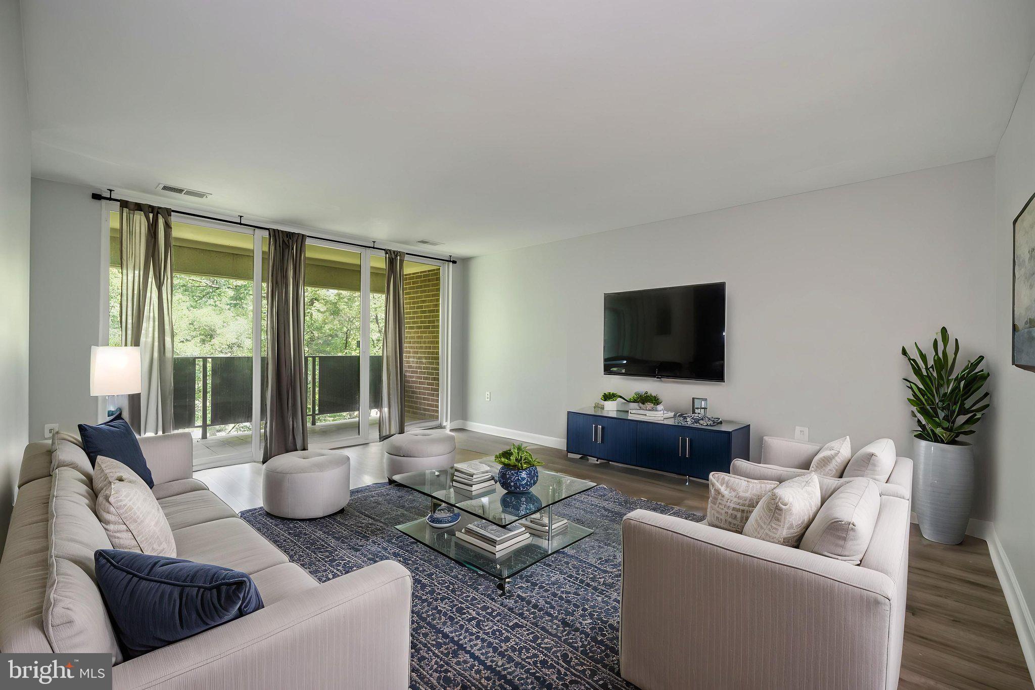 1443 Northgate Square, Unit 22B Reston, VA 20190 - Photo 2 of 42 a living room with furniture and a flat screen tv