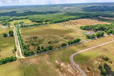 an aerial view of swimming pool with a yard