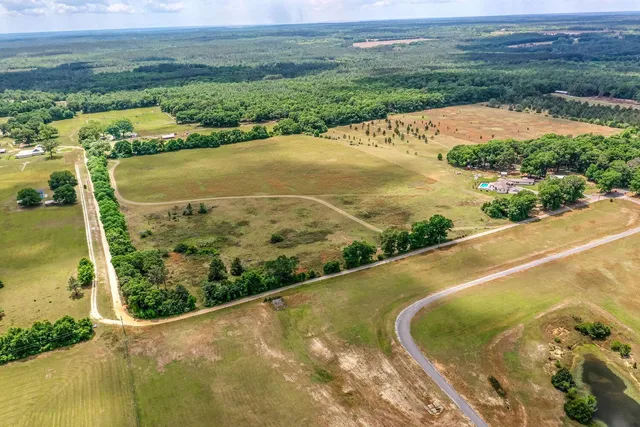 an aerial view of a house with a big yard