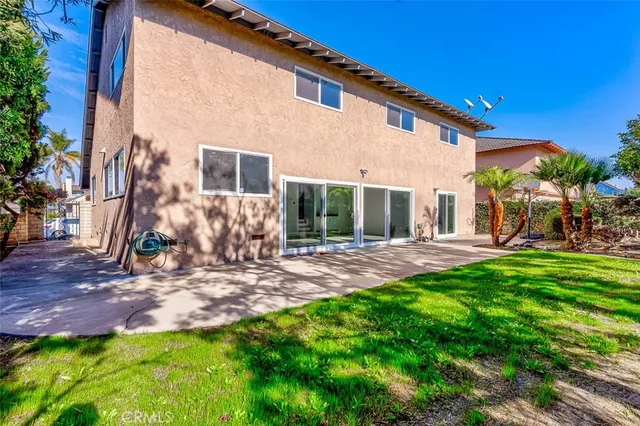 a view of a backyard with a plants and large tree