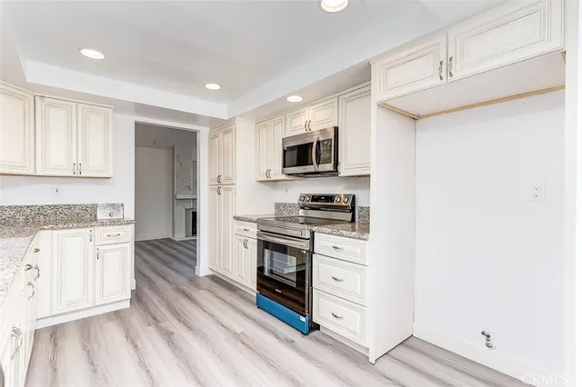 a kitchen with stainless steel appliances a stove and a refrigerator