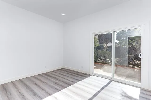 a room with a bed and glass door