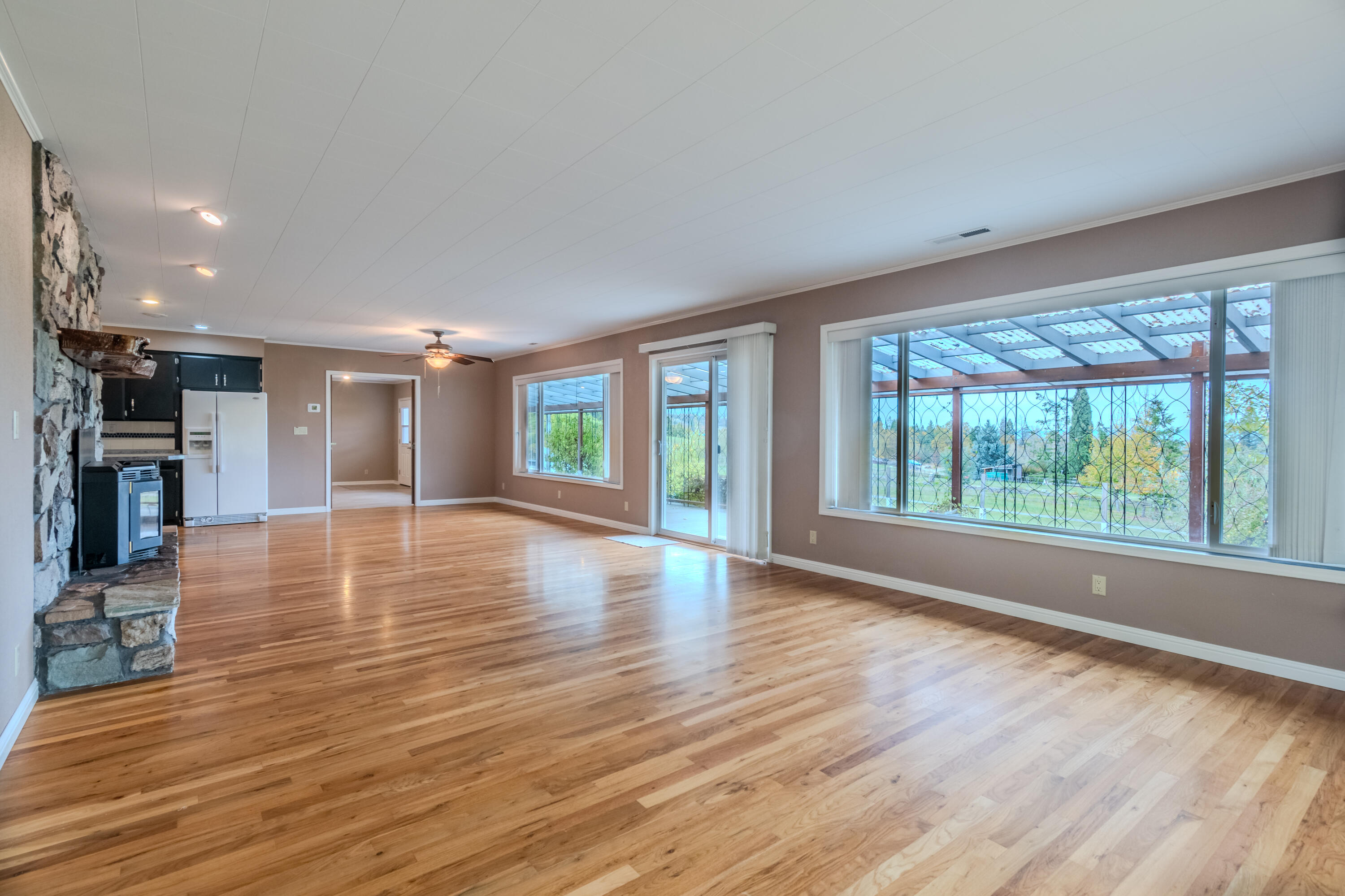 8192 Yank Gulch Road Talent, OR 97540 - Photo 11 of 34 a view of an empty room with wooden floor and a window