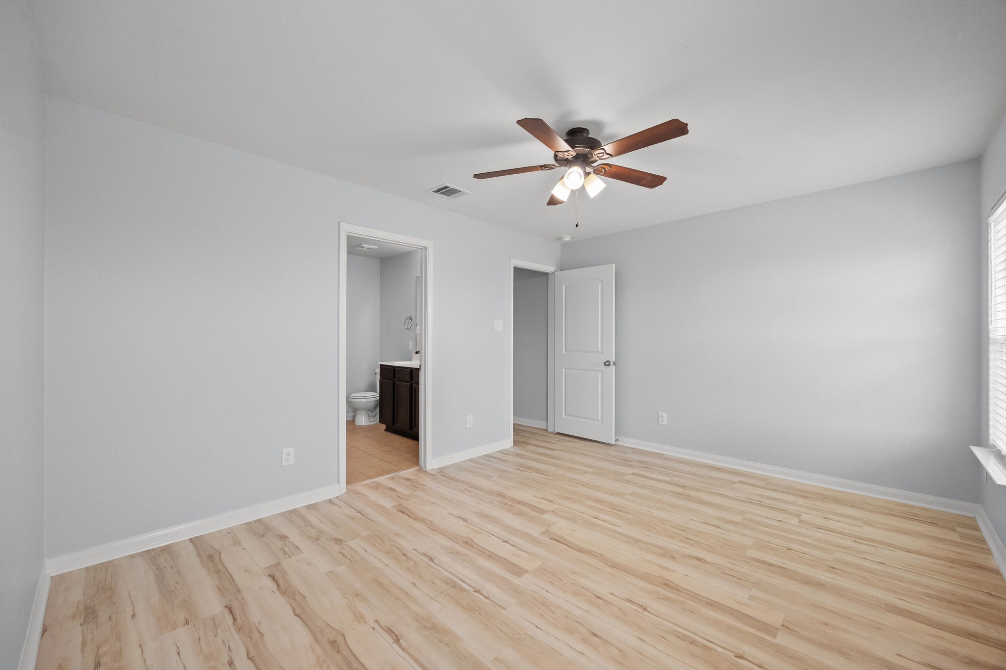228 Millers Loop Jarrell, TX 76537 - Photo 9 of 26 Smooth wood-look flooring and clean lines define this versatile bedroom suite.