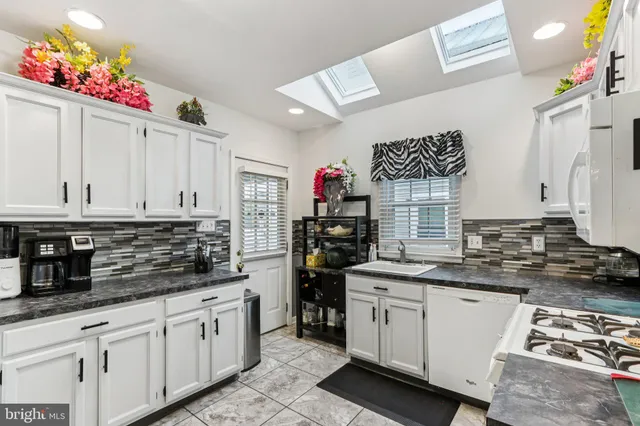 a kitchen with stainless steel appliances granite countertop a stove and a refrigerator