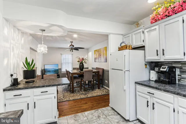 a view of a dining room with furniture and a potted plant
