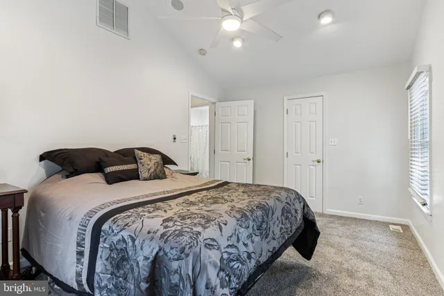 a view of walk in closet with clothes