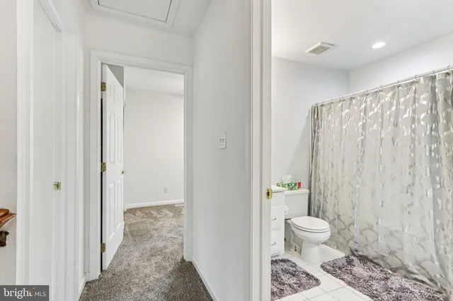 a bedroom with a bed a window and ceiling fan