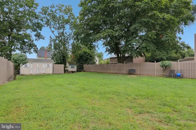 an aerial view of multiple houses with yard