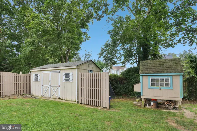 an aerial view of residential houses with outdoor space and street view
