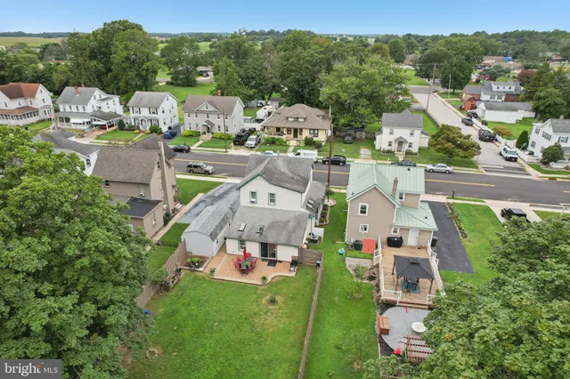 an aerial view of residential houses with city view