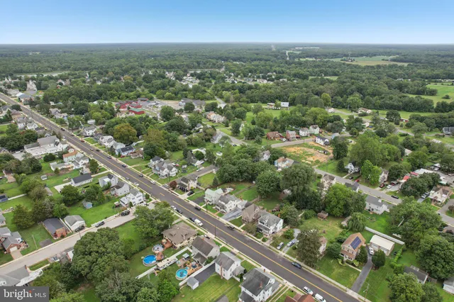 an aerial view of a house with yard swimming pool and outdoor seating