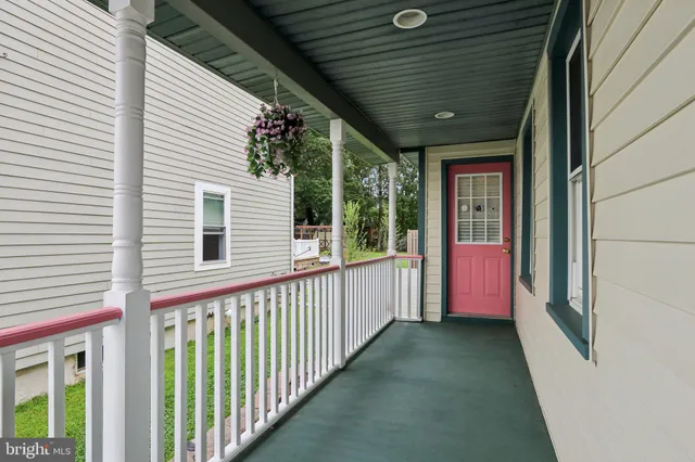 a view of a porch with furniture and floor to ceiling window