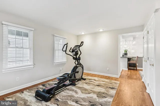 a room with gym equipment and a rug