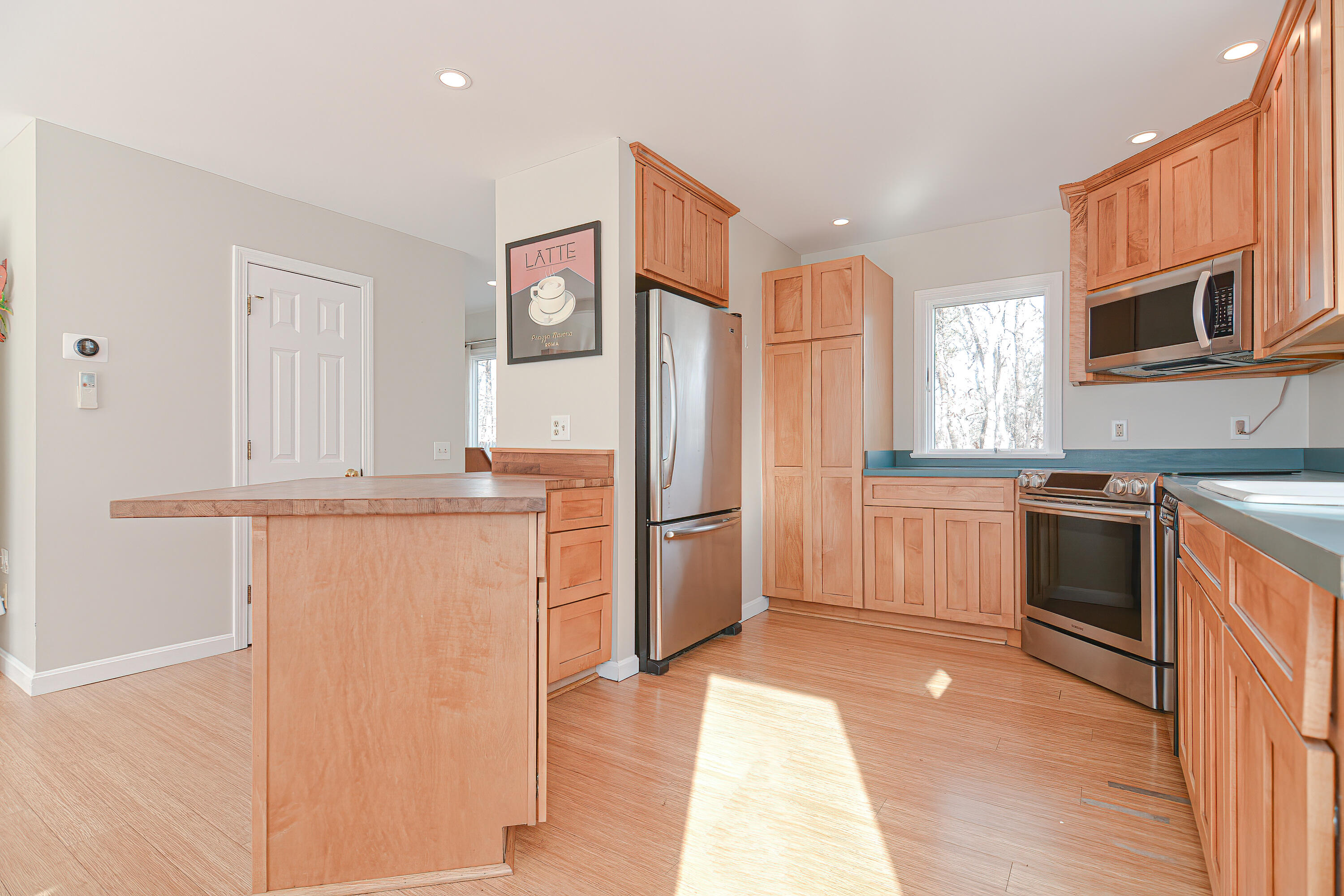 155 Gross Hill Road Wellfleet, MA 02667 - Photo 11 of 52 a kitchen with stainless steel appliances a refrigerator sink and microwave