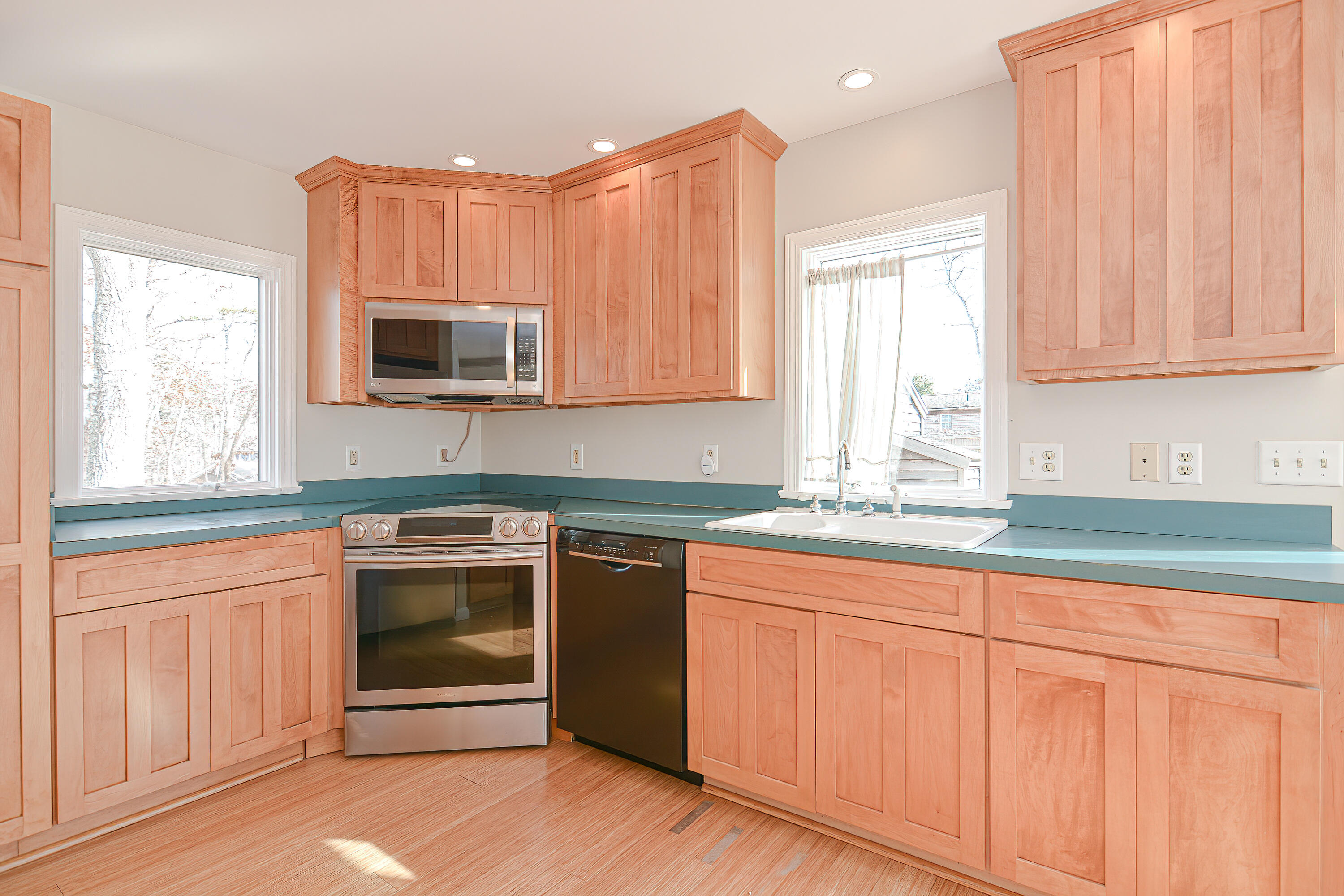 155 Gross Hill Road Wellfleet, MA 02667 - Photo 12 of 52 a kitchen with granite countertop a sink and a stove top oven