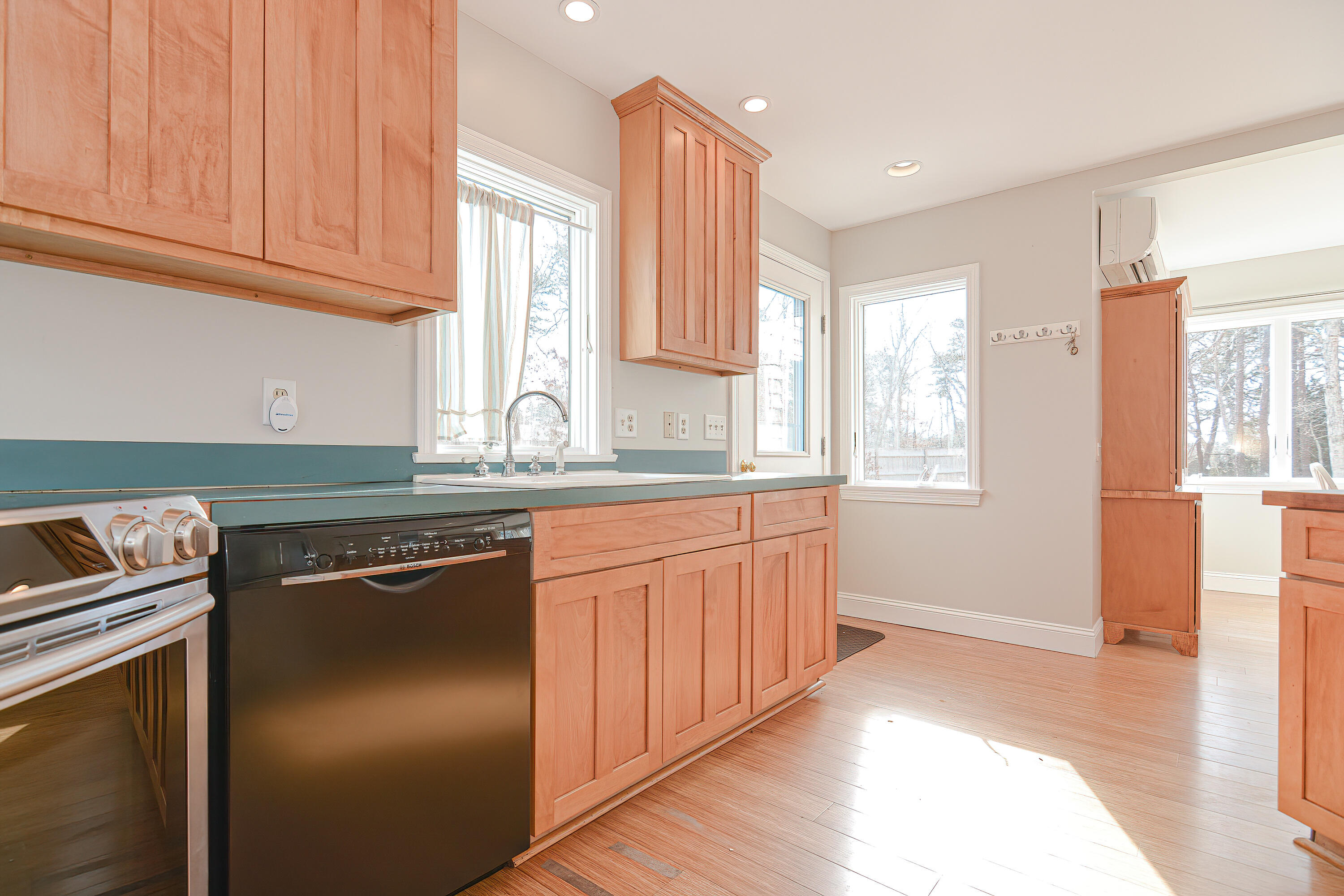 155 Gross Hill Road Wellfleet, MA 02667 - Photo 13 of 52 a kitchen with stainless steel appliances granite countertop a refrigerator a sink dishwasher a stove and white countertops with wooden floor