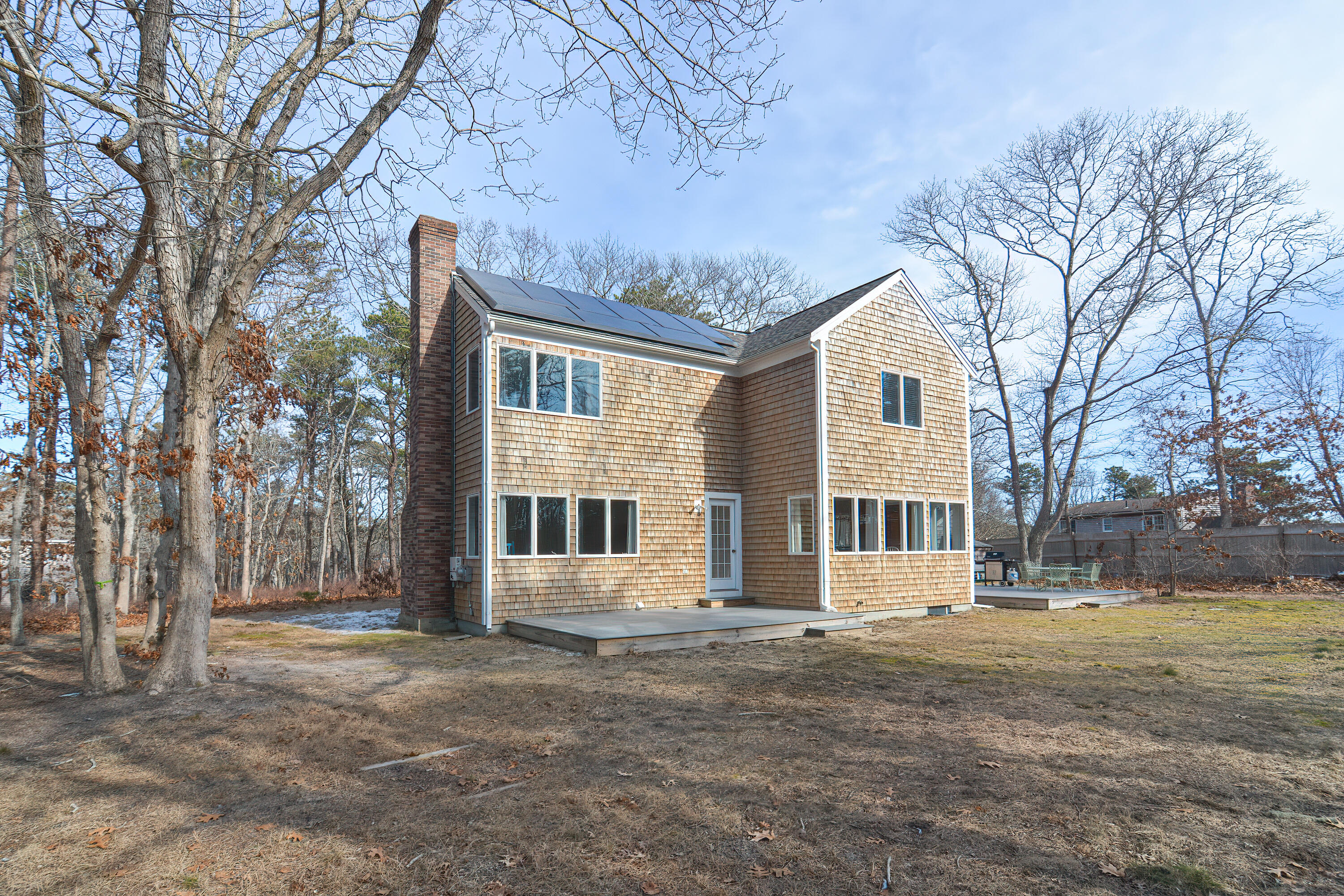 155 Gross Hill Road Wellfleet, MA 02667 - Photo 2 of 52 a front view of a house with a yard