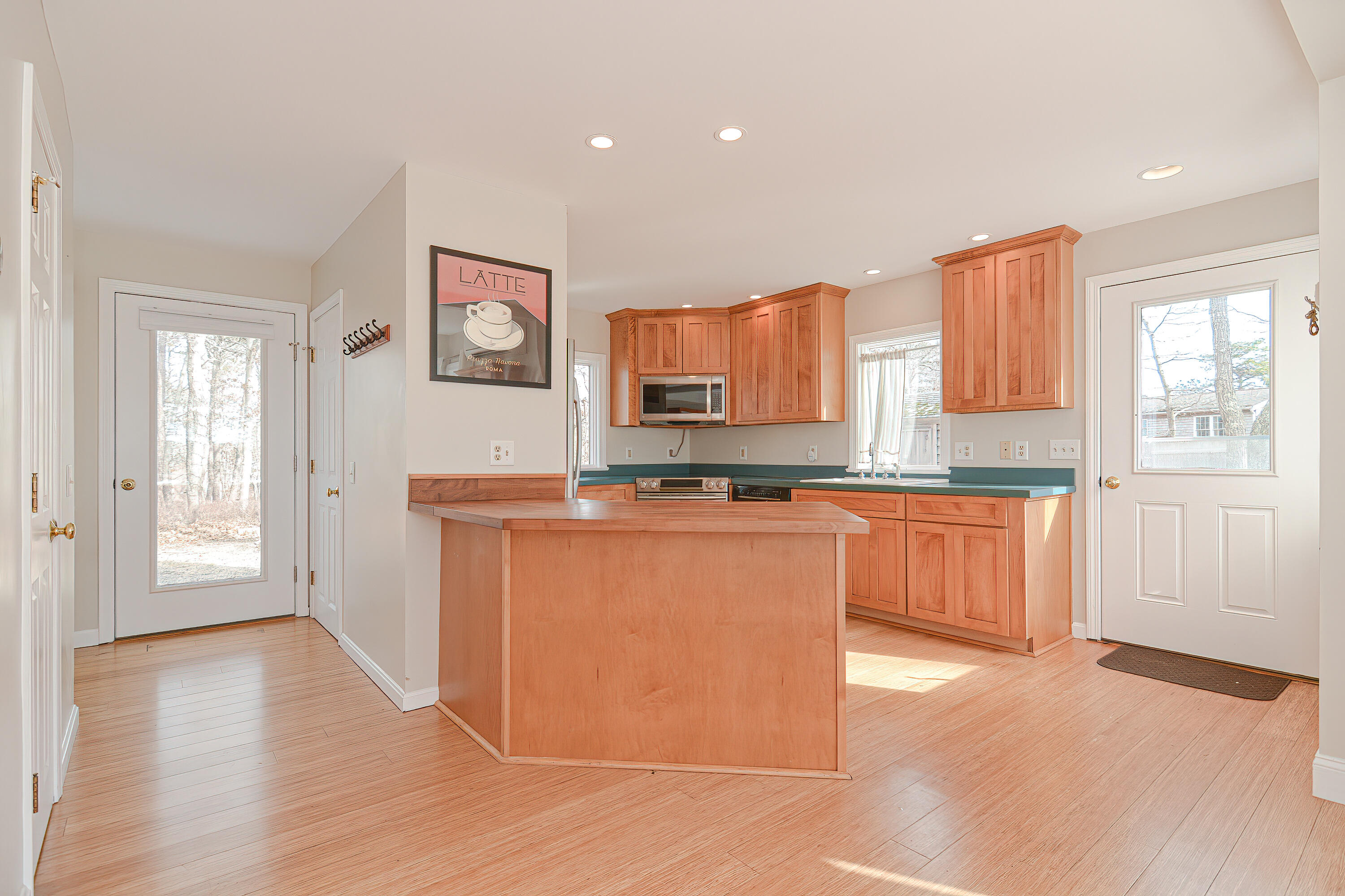 155 Gross Hill Road Wellfleet, MA 02667 - Photo 10 of 52 a large kitchen with stainless steel appliances granite countertop a stove a sink and a refrigerator