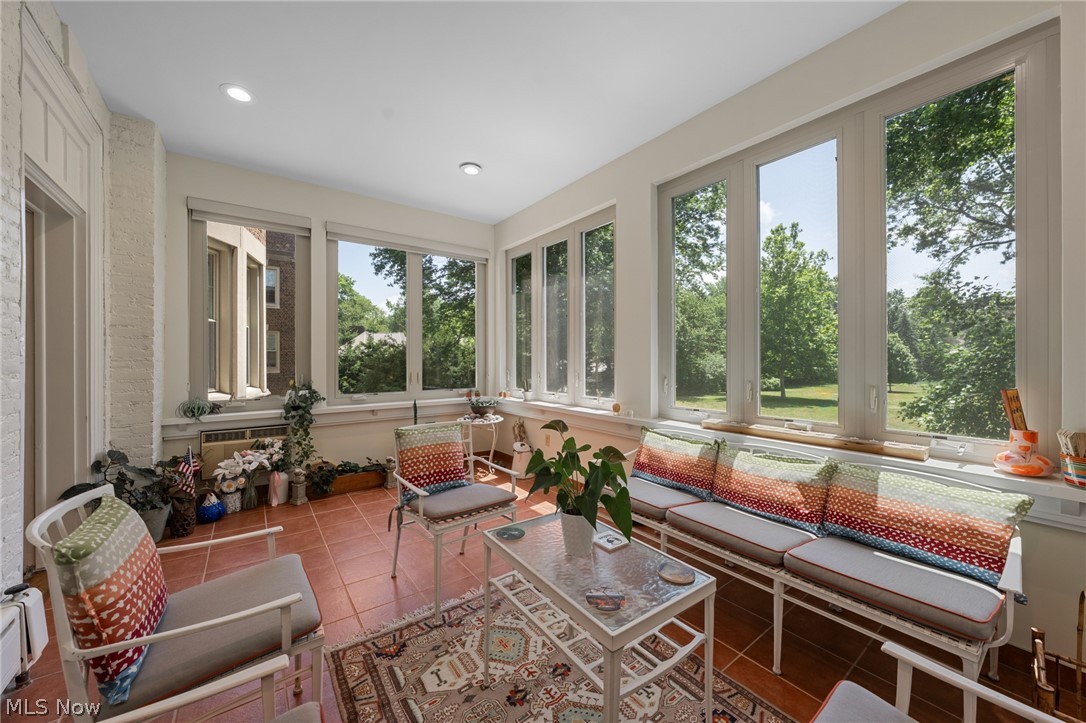 12546 Cedar Road, Unit 4 Cleveland Heights, OH 44106 - Photo 6 of 43 Spectacular 4 season sunroom with ceramic tile floor that overlooks a 2-acre park like area with a patio and lily pond, perfect for alfresco dining and cookouts.