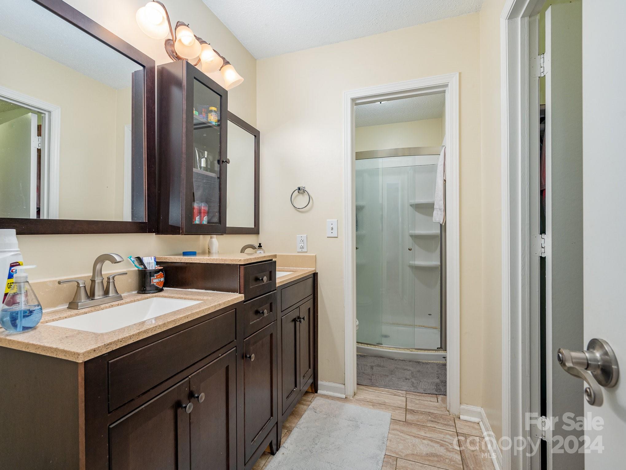 11625 Park Road Charlotte, NC 28226 - Photo 12 of 28 a bathroom with a sink vanity and a mirror