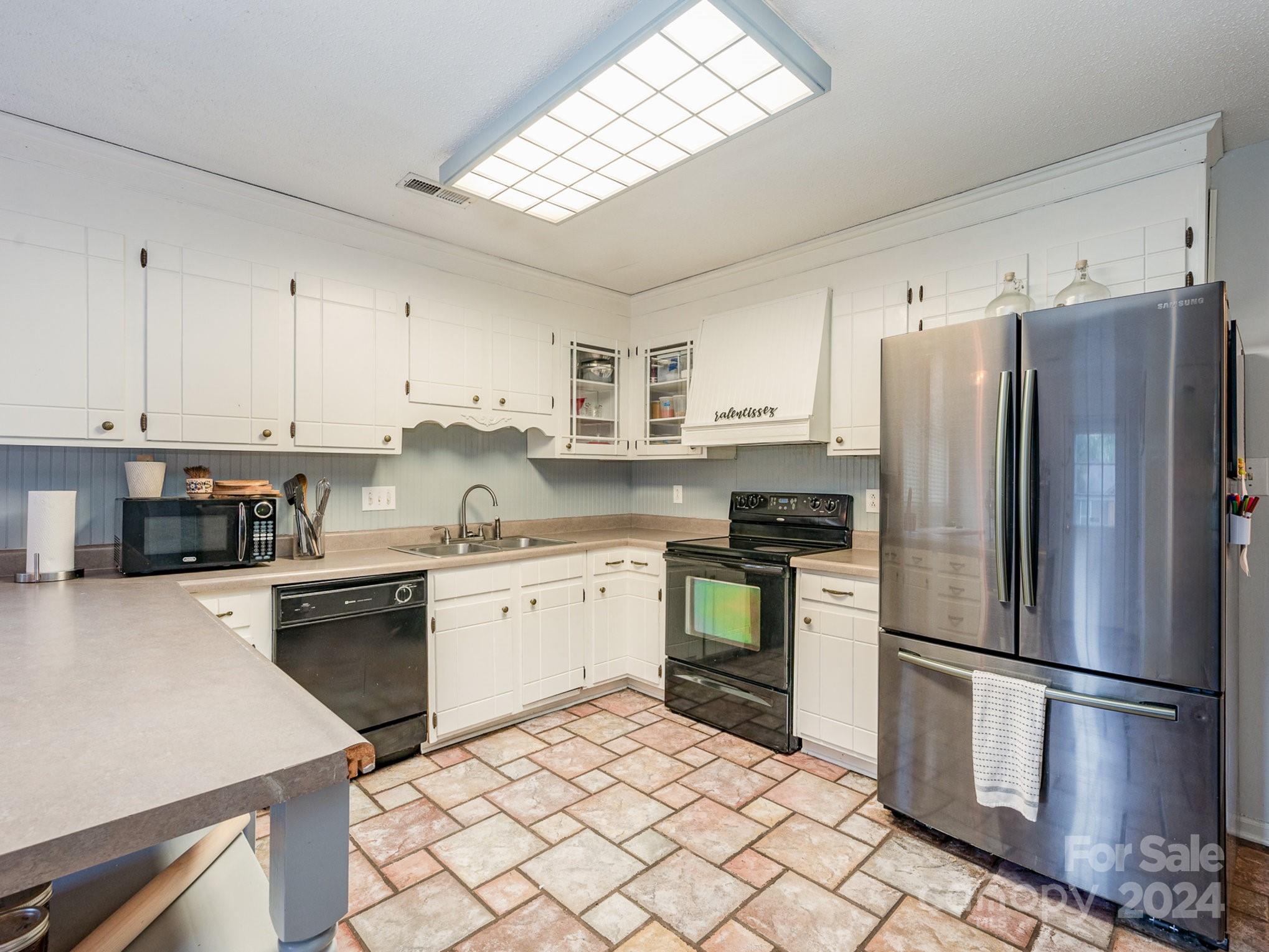 11625 Park Road Charlotte, NC 28226 - Photo 19 of 28 a kitchen with granite countertop stainless steel appliances a sink a stove a refrigerator a window and cabinets