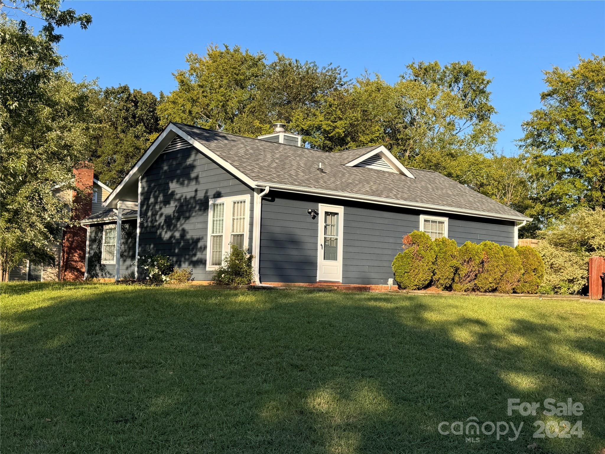 11625 Park Road Charlotte, NC 28226 - Photo 2 of 28 a front view of a house with a garden