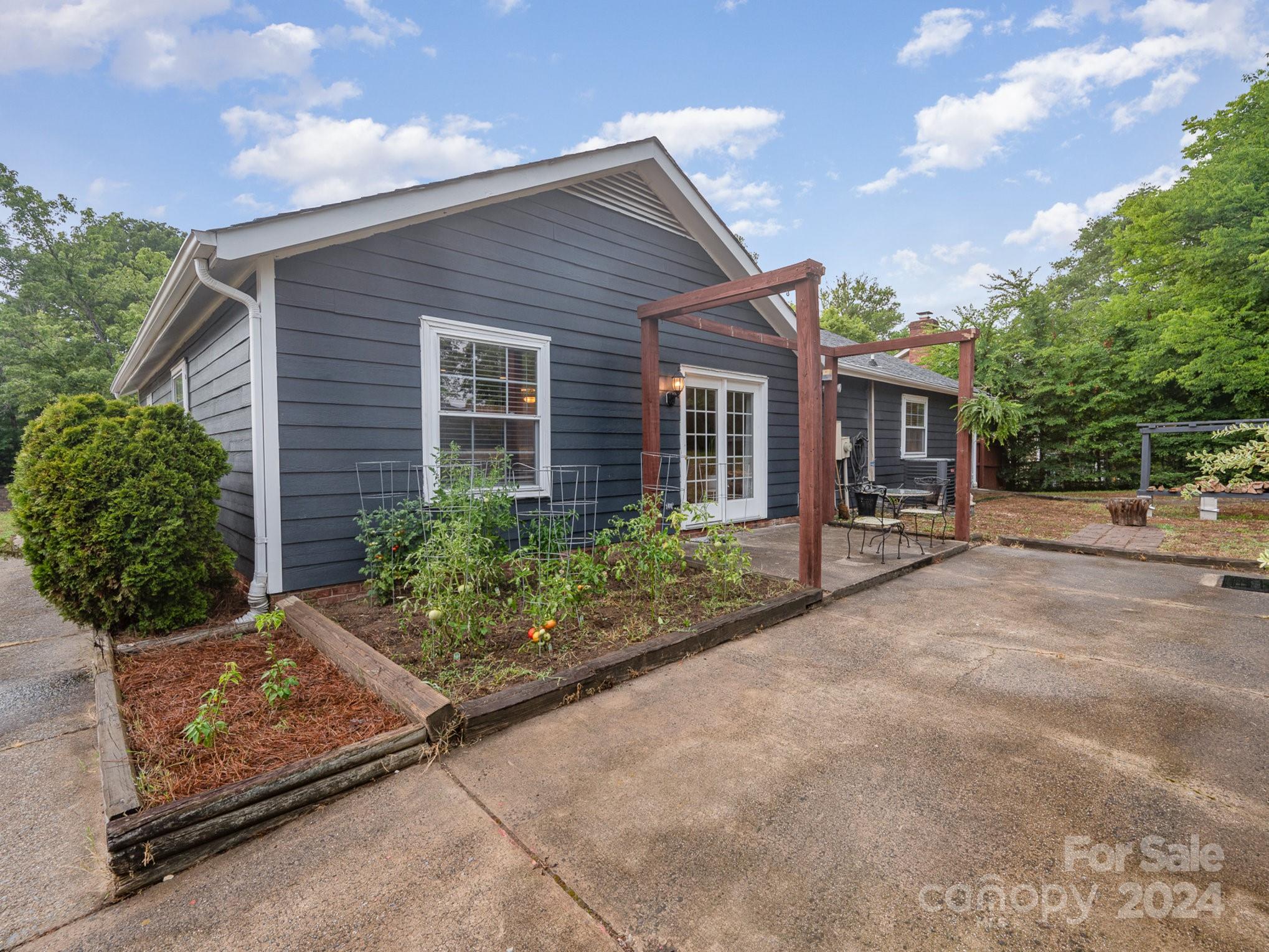 11625 Park Road Charlotte, NC 28226 - Photo 21 of 28 a front view of a house with garden