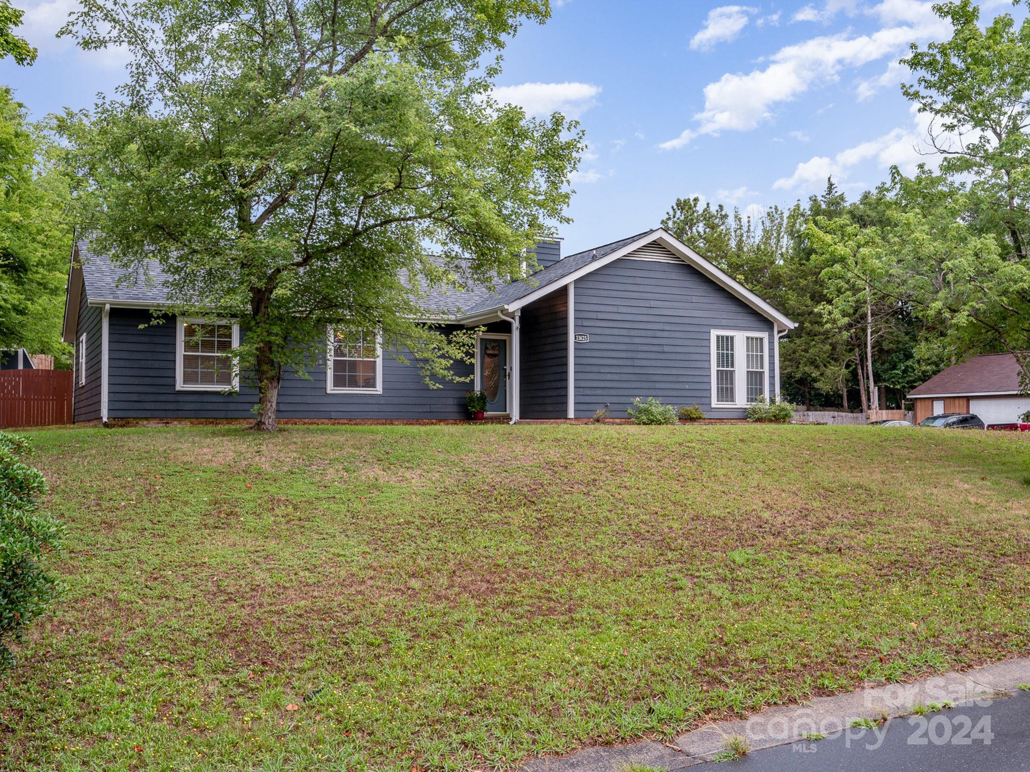 11625 Park Road Charlotte, NC 28226 - Photo 24 of 28 a front view of a house with a garden
