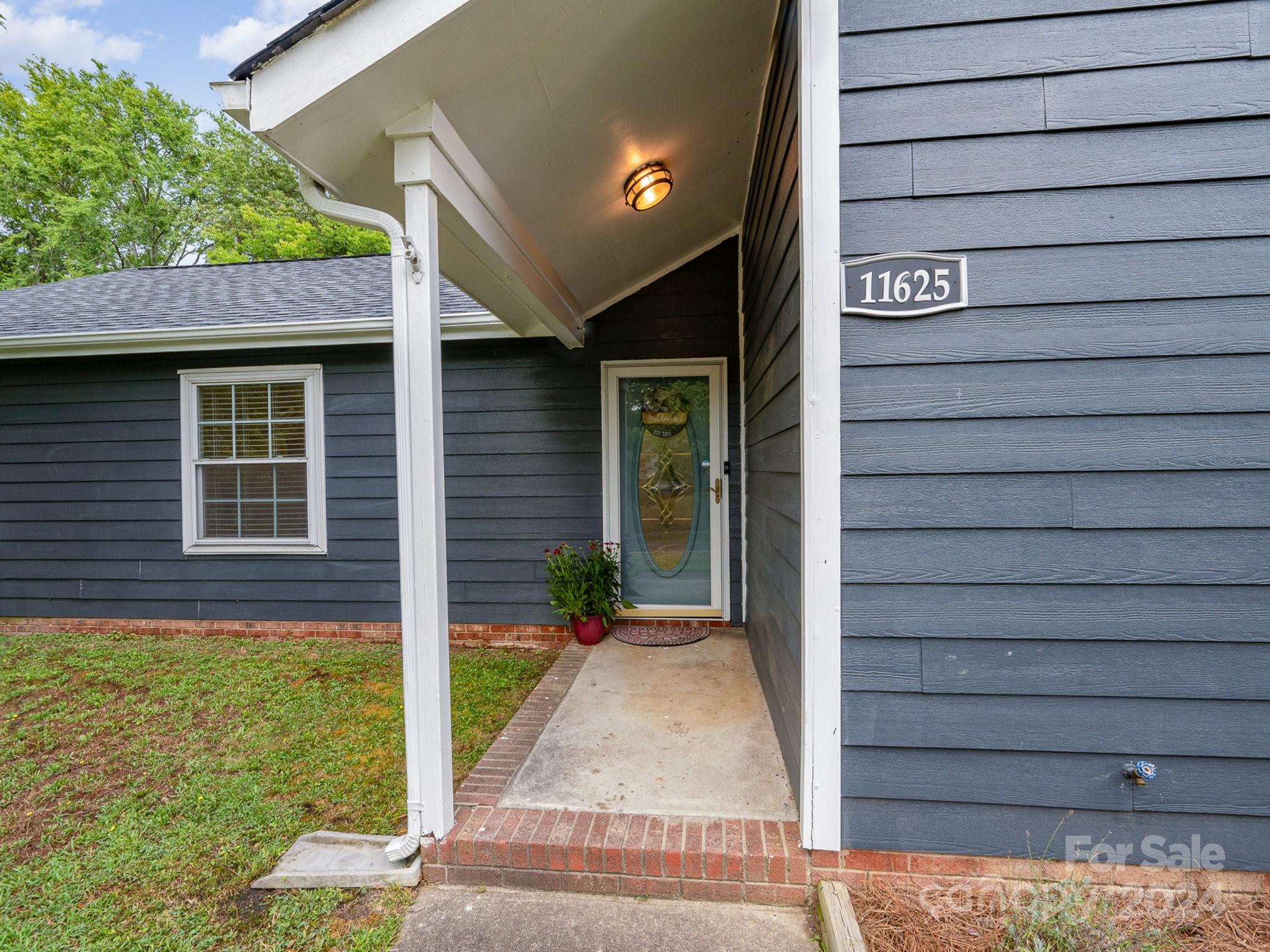 11625 Park Road Charlotte, NC 28226 - Photo 3 of 28 a front view of a house with a yard